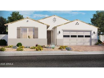 Charming single-story home with neutral tones, desert landscaping, and a two-car garage at 17788 W Odeum Ln, Goodyear, AZ 85338