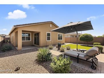 Cozy backyard featuring desert landscaping, artificial turf, and comfortable lounge seating at 22560 E Rosa Rd, Queen Creek, AZ 85142