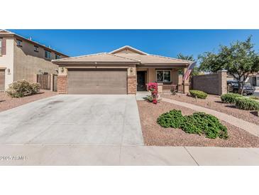 Charming single-story home featuring a tidy front yard, neutral color palette and a welcoming entrance at 3915 S 186Th Ln, Goodyear, AZ 85338