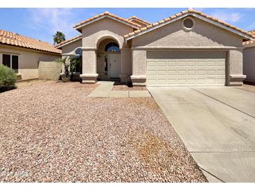 Charming single-story home with a two-car garage, low maintenance landscaping, and a classic Southwestern design at 4626 E Villa Rita Dr, Phoenix, AZ 85032