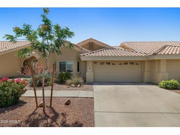 Charming single-story home featuring a tile roof, desert landscaping, and a two-car garage at 5830 E Mckellips Rd # 2, Mesa, AZ 85215