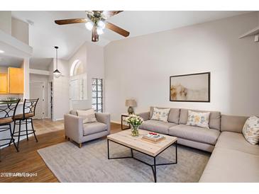 Inviting living room with vaulted ceilings, plush seating, and a stylish coffee table creates a warm and welcoming space at 5830 E Mckellips Rd # 2, Mesa, AZ 85215