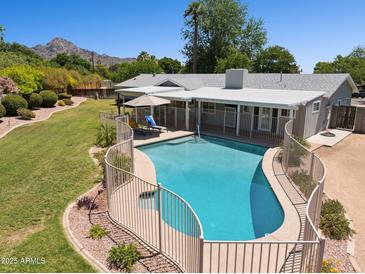 Gorgeous fenced pool area with ample space for lounging and a well-maintained yard at 7042 N 13Th St, Phoenix, AZ 85020