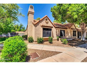 Charming home featuring a stucco exterior, red tile roof, and neatly landscaped front yard at 921 W University Dr # 1023, Mesa, AZ 85201
