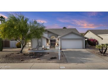 Charming single-story home features a well-maintained yard and inviting front porch at 9826 W Tonto Ln, Peoria, AZ 85382