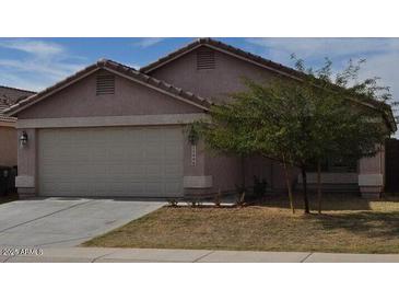 Charming single-story home featuring a two-car garage and xeriscaped front yard at 13606 N 130Th Ave, El Mirage, AZ 85335