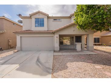 Two-story home with a two car garage, desert landscaping, and a welcoming front porch at 13706 N 130Th Ave, El Mirage, AZ 85335