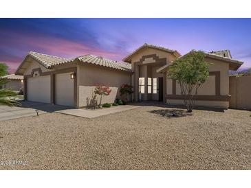 Charming single-story home with a neutral color palette, low maintenance yard, and convenient two-car garage at 14821 N 42Nd St, Phoenix, AZ 85032