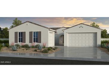 Beautiful single-story home featuring a two-car garage, desert landscaping, and neutral exterior paint at 17118 W Hackamore Dr, Surprise, AZ 85387