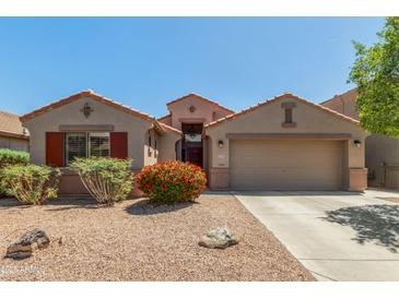 Inviting single-story home featuring a two-car garage and beautifully landscaped front yard with desert landscaping at 42505 W Venture Rd, Maricopa, AZ 85138