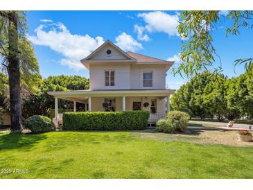 Charming two-story home with manicured lawn, inviting porch, and lush greenery at 7252 N Central Ave, Phoenix, AZ 85020
