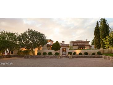 Stunning desert home featuring a gated motor court and lush landscaping at 7525 N Shadow Mountain Rd, Paradise Valley, AZ 85253