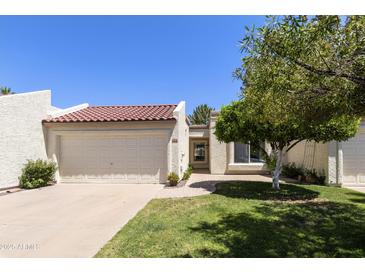 Charming single-story home with a red tile roof, a two-car garage, and a well-manicured front yard at 7834 E Mariposa Way, Mesa, AZ 85208