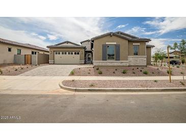 Beautiful single-Gathering home featuring a three-car garage and low-maintenance landscaping at 9705 E Sector Dr, Mesa, AZ 85212