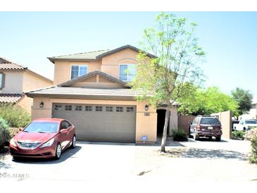 Charming two-story home with a well-maintained front yard and a spacious two-car garage at 1417 E Rosebud Dr, San Tan Valley, AZ 85143