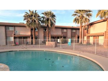 Community pool with palm trees at this townhome complex at 1750 E Mateo Cir # 106, Mesa, AZ 85204