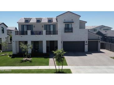 Well-manicured two-story home exterior showcasing a meticulously kept lawn and a charming facade at 3669 E Boot Track Trl, Gilbert, AZ 85296