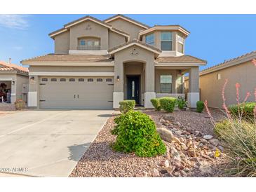 Charming two-story home with a well-manicured desert rock landscape in front at 10351 W Carlota Ln, Peoria, AZ 85383