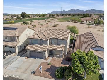 Exterior view of home with tile roof, two-car garage, and front yard with desert landscaping at 12209 W Washington St, Avondale, AZ 85323