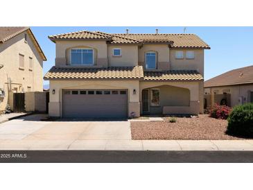 Two-story home showcasing a tile roof, neutral stucco, and a two-car garage at 12209 W Washington St, Avondale, AZ 85323