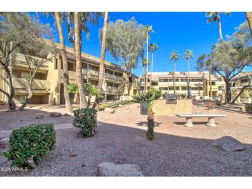 Well-maintained community area with barbecue grills, seating, and lush landscaping creating a welcoming outdoor space at 1331 W Baseline Rd # 120, Mesa, AZ 85202