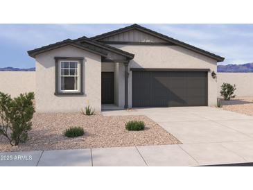 Charming single-story home with a neutral color palette, two-car garage, and desert landscaping at 18243 W La Senda Dr, Surprise, AZ 85387