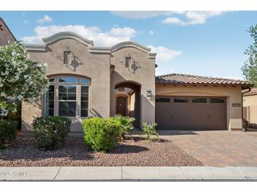 Inviting single-story home featuring a desert landscape and a charming arched entryway to welcome you at 18530 E Mockingbird Ct, Queen Creek, AZ 85142