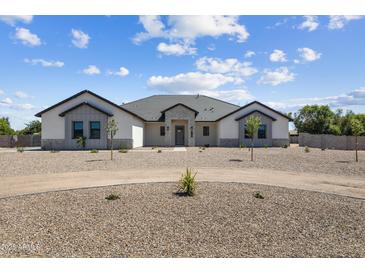Charming one-story home featuring stone accents, low-maintenance landscaping, and a circular driveway at 3989 E Freeman Ln, San Tan Valley, AZ 85140