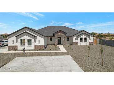 Beautiful single-story home featuring a modern design, manicured landscaping and a paved driveway at 3989 E Freeman Ln, San Tan Valley, AZ 85140