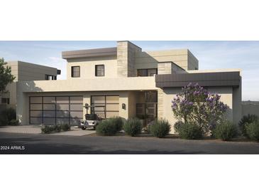 Stunning modern home with a beige exterior, black accents, and desert landscaping at 4915 N Ascent Dr, Scottsdale, AZ 85251