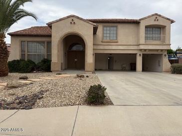 Charming two-story home featuring an arched entrance and a spacious three-car garage at 9556 W Blue Sky Dr, Peoria, AZ 85383
