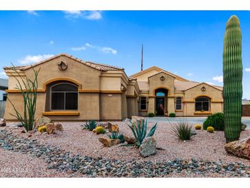 Charming single-story home with desert landscaping, decorative rock, and a private yard at 10040 E Grandview St, Mesa, AZ 85207