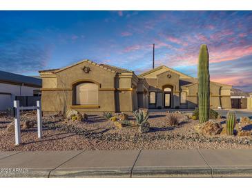 Stunning exterior view of the single story home featuring desert landscaping and a private driveway at 10040 E Grandview St, Mesa, AZ 85207