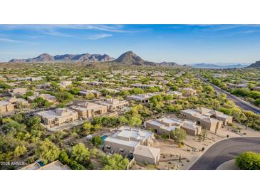 Expansive aerial view of a desert community with luxurious homes and stunning mountain backdrop on a clear day at 11123 E Monument Dr, Scottsdale, AZ 85262