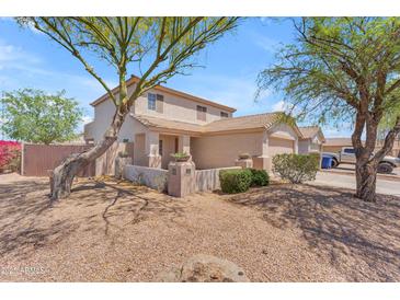 Charming two-story home featuring desert landscaping, a cozy front porch, and a classic tile roof at 12630 W Corrine Dr, El Mirage, AZ 85335