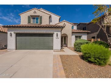 Charming two-story home featuring a two-car garage, desert landscaping, and a classic stucco facade at 1634 W Red Bird Rd, Phoenix, AZ 85085