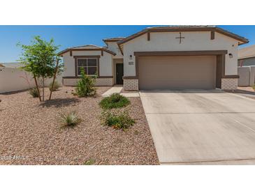 Charming single-Gathering home featuring a two-car garage and a low maintenance desert landscaped front yard at 37008 N Hinterwald Way, San Tan Valley, AZ 85143