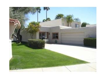 Charming single-story home with a well-manicured lawn and attached two-car garage at 4107 E Bloomfield Rd, Phoenix, AZ 85032