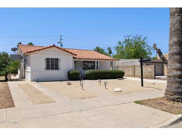 Lovely single-story home with desert landscaping, walkway and red tile roof at 541 W Vernon Ave, Phoenix, AZ 85003