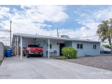 Charming single-story home featuring a carport, long driveway, and easy-care landscaping at 1017 W Piccadilly Rd, Phoenix, AZ 85013