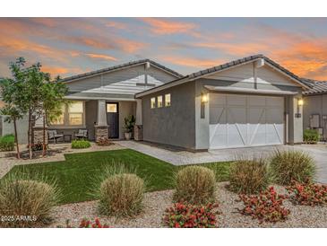 Beautiful single-Gathering home with lush landscaping, a two-car garage, and a welcoming front porch at 17362 W Wildwood St, Surprise, AZ 85388