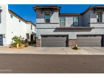 Charming two-story home with a gray stucco exterior and well-maintained front yard at 1829 N 43Rd Ter, Phoenix, AZ 85008