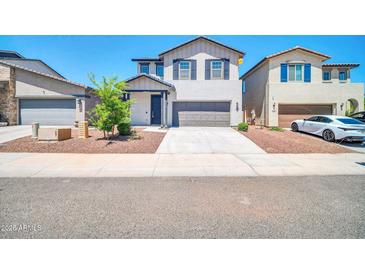 Two-story home featuring a two-car garage and neutral color scheme at 20808 W Granada Rd, Buckeye, AZ 85396