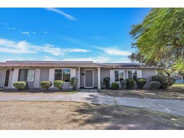 Charming single-story home featuring a well-manicured front yard and neutral exterior paint at 5008 W New World Dr, Glendale, AZ 85302