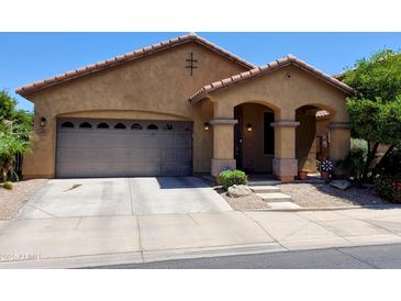 Charming single-story home with a well-manicured front yard and two car garage at 6191 S Pearl Dr, Chandler, AZ 85249