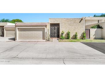 Beige single-story home showcasing a front yard, garage, and secure front door at 6226 N 21St Dr, Phoenix, AZ 85015