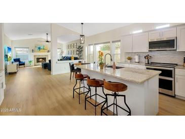 Bright, open kitchen featuring granite countertops, stainless appliances, and inviting seating at the island at 824 W Mesquite St, Gilbert, AZ 85233