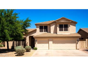 Charming two-story home with a well-manicured lawn and a two car garage at 9052 E Hobart St, Mesa, AZ 85207