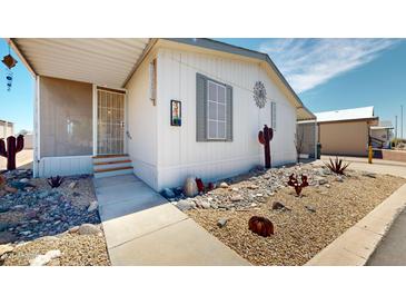 Well-maintained home featuring desert landscaping and a charming, enclosed front porch at 11596 W Sierra Dawn Blvd # 33, Surprise, AZ 85378