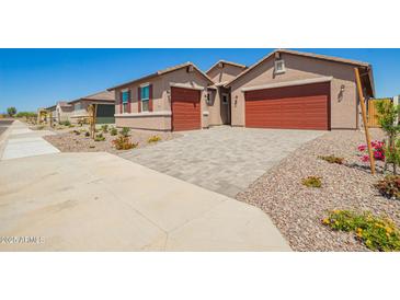 Beautiful single-Gathering home with a two-car garage and a well-maintained front yard and a driveway at 25221 N 131St Dr, Peoria, AZ 85383
